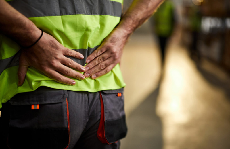 man with back pain on the job 1 - Work-Related Injuries